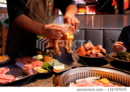 Unique dining experience with a special meat service at a vibrant restaurant in the evening Unique dining experience with a special meat service at a vibrant restaurant in the evening 136797645