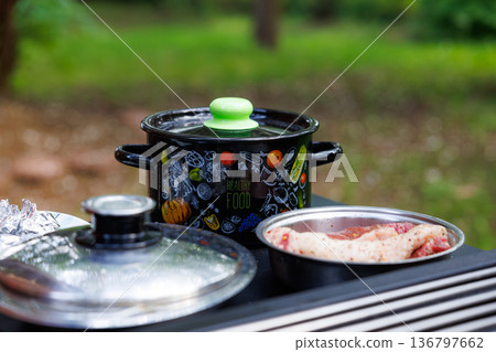 Enjoying a delightful outdoor cooking session with fresh ingredients in a sunny garden Enjoying a delightful outdoor cooking session with fresh ingredients in a sunny garden 136797662