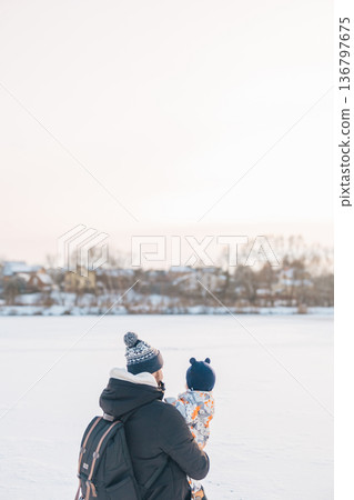 Father and child enjoying winter outdoors Father and child enjoying winter outdoors 136797675
