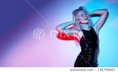 Dancer Woman Under Colorful Gel Lighting, Moving With Rhythm And Sparkle, Sequined Dress Catching Neon Red And Blue Gels, Energetic Party Atmosphere, Joyful Expression And Dynamic Pose Conveying Dancer Woman Under Colorful Gel Lighting, Moving With Rhythm And Sparkle, Sequined Dress Catching Neon Red And Blue Gels, Energetic Party Atmosphere, Joyful Expression And Dynamic Pose Conveying 136799061