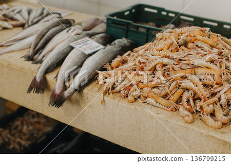 Fresh fish and shrimps on ice at the traditional fish market. 136799215