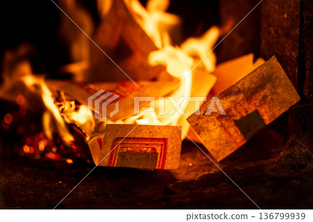 The instant the paper money burned fiercely inside the incense burner The instant the paper money burned fiercely inside the incense burner 136799939