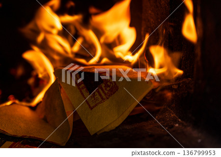 The instant the paper money burned fiercely inside the incense burner The instant the paper money burned fiercely inside the incense burner 136799953
