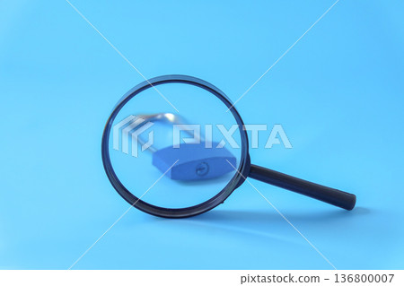 A magnifying glasses to lock on background.A magnifying glasses to lock on background. A magnifying glasses to lock on background.A magnifying glasses to lock on background. 136800007