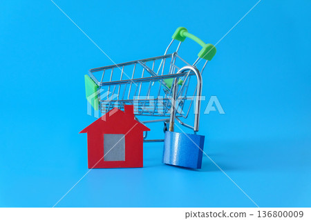 Mini red house and lock on background. 136800009