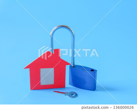Mini red house and lock on background. 136800026