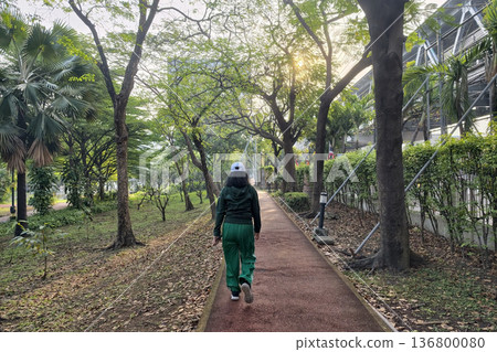Asian woman walking exercise in park at sunrise, Bangkok Asian woman walking exercise in park at sunrise, Bangkok 136800080