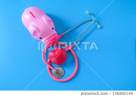 piggy bank with stethoscope and red heart on color background. 136800149