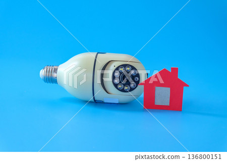 Security camera cctv and mini house on color background. Security camera cctv and mini house on color background. 136800151