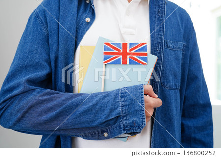 Learn English language, Asian teenage student hold book with flag in course at school. 136800252