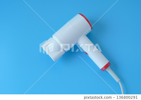 Fashionable hair dryer for hairdressing on blue background. Fashionable hair dryer for hairdressing on blue background. 136800291