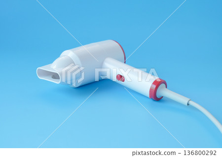 Fashionable hair dryer for hairdressing on blue background. 136800292