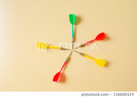 Colorful plastic darts arrow on color background. 136800324