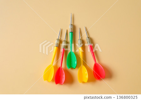 Colorful plastic darts arrow on color background. 136800325