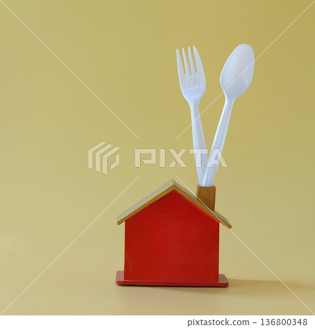 Mini red house with spoon and fork . Mini red house with spoon and fork . 136800348