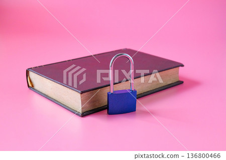 A lock with leather old book on background. 136800466