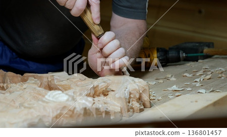 Woodcraft with tools, Skilled artisan carving wood amidst modern and traditional instruments, Hand sculptor engaged in detailed woodworking using range of vintage and contemporary tools 136801457