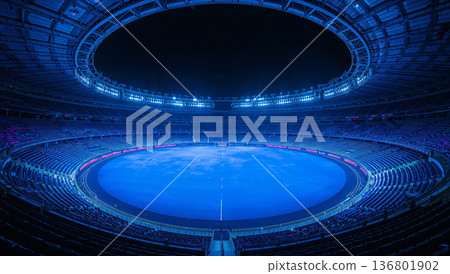 Vast empty stadium illuminated with vibrant blue lights at night 136801902