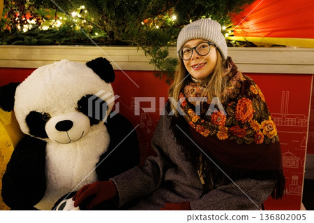 Smiles and warmth with a cozy panda friend at a festive winter market Smiles and warmth with a cozy panda friend at a festive winter market 136802005