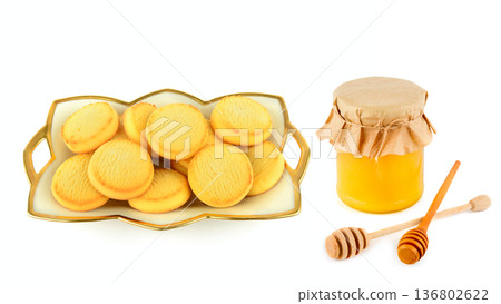 Golden Shortbread Biscuits and Honey Jar with Wooden Dippers 136802622