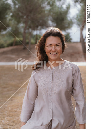 Smiling Woman Enjoying Outdoor Scenery in Nature Smiling Woman Enjoying Outdoor Scenery in Nature 136803512