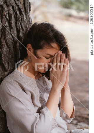 Woman Practicing Mindful Prayer Outdoors Woman Practicing Mindful Prayer Outdoors 136803514