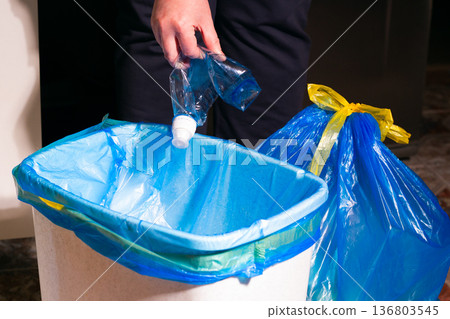 Woman putting used plastic bottle in waste bin, separate waste collection and recycling concept. High quality photo 136803545