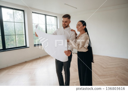 Guidance by the plan. Man and woman are in the modern new room, conception of business 136803616