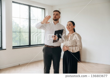 Man and woman are in the modern new room, conception of business Man and woman are in the modern new room, conception of business 136803677