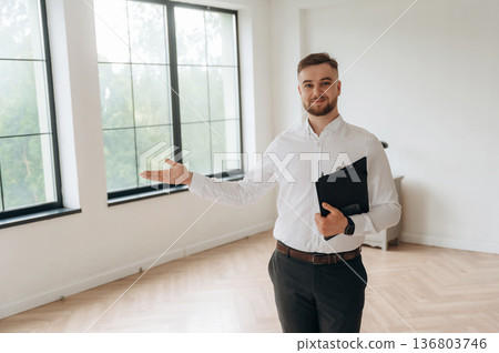 Real estate agent is in the new room 136803746
