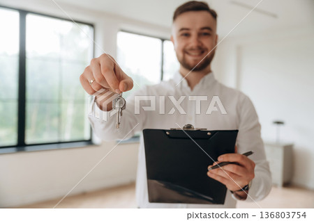 Real estate agent is in the new room 136803754