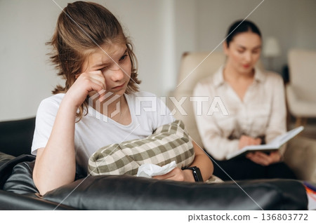 Tired, crying. Girl at a psychologist's appointment 136803772