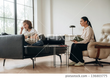 Don't want to talk, feeling depressed. Girl at a psychologist's appointment Don't want to talk, feeling depressed. Girl at a psychologist's appointment 136803775