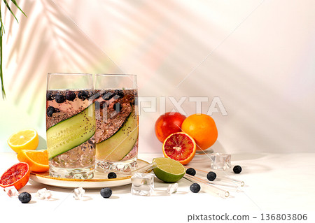 Diet vegan cocktail with cucumber, lemon, lime, blueberry and chia seeds, detox diet and weight loss concept, healthy lifestyle and healthy food advertising, cafe menu. Modern still life with drinks. Diet vegan cocktail with cucumber, lemon, lime, blueberry and chia seeds, detox diet and weight loss concept, healthy lifestyle and healthy food advertising, cafe menu. Modern still life with drinks. 136803806