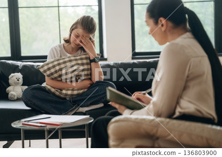 Tired, crying. Girl at a psychologist's appointment Tired, crying. Girl at a psychologist's appointment 136803900