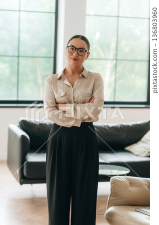 Woman in formal clothes is in the modern big room 136803960