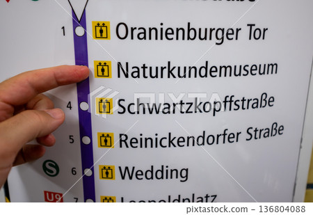Berlin, germany, august 15, 2023. Tourist finger points at naturkundemuseum station on berlin u-bahn map, planning an urban subway route and city itinerary 136804088