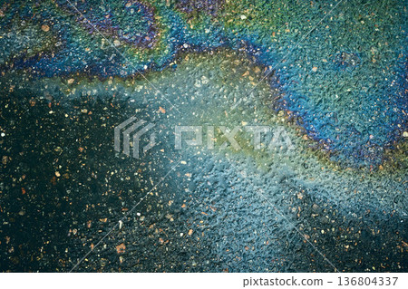 Iridescent oil slick on asphalt, creating a dynamic abstract composition 136804337