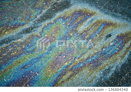 Oil Spill on Pavement Reflects Various Colors in Sunlight During Midday Oil Spill on Pavement Reflects Various Colors in Sunlight During Midday 136804348