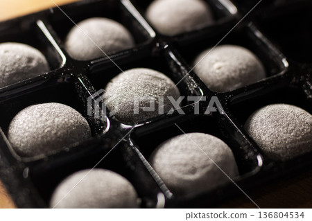 Arrangement of dusted chocolate spheres. Closeup of packaged chocolate truffle arrangement Arrangement of dusted chocolate spheres. Closeup of packaged chocolate truffle arrangement 136804534