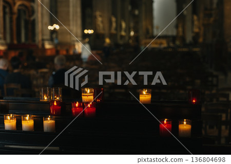 Burning candles in an old church. Burning candles in an old church. 136804698