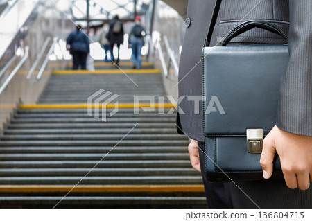 Businessman ascends stairs Businessman ascends stairs 136804715