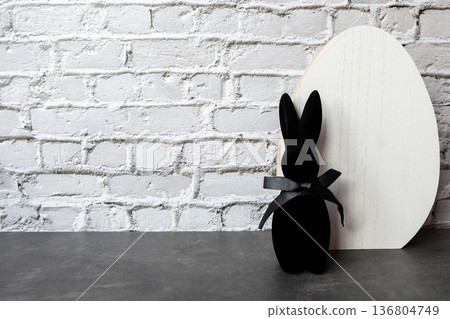 Black rabbit and egg for easter on the stone background. Shopping of Easter holidays. Space for text. 136804749