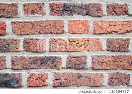 Brown structural stone wall of the ancient building consists of bricks. Nature structural background. Brown structural stone wall of the ancient building consists of bricks. Nature structural background. 136804877
