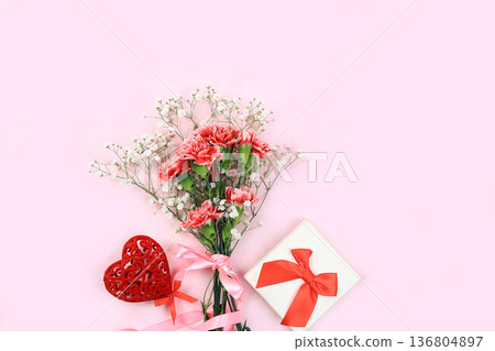 Abstract floral composition, spring background. Carnations on pink background, minimal holiday concept. Postcard for womens day or mothers day, happy birthday, wedding, banner for the screen, 136804897