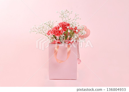 Carnations in a pink box, abstract spring floral background. Creative modern bouquet, minimal holiday concept. Postcard for womens day or mothers day, happy birthday, wedding, banner for the screen, Carnations in a pink box, abstract spring floral background. Creative modern bouquet, minimal holiday concept. Postcard for womens day or mothers day, happy birthday, wedding, banner for the screen, 136804933