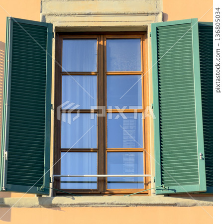 Warm Mediterranean Setting Features Open Shutters Reflecting Blue Sky 136805034