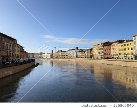 Gentle Rays Illuminate Lively Skyline Along Tranquil Waterway Gentle Rays Illuminate Lively Skyline Along Tranquil Waterway 136805040