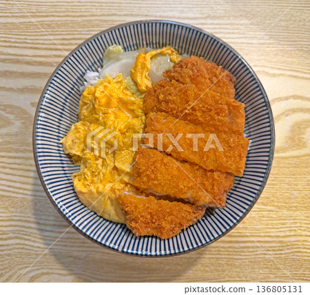 Delicious Japanese Katsu Donburi with scrambled eggs and rice in a bowl Delicious Japanese Katsu Donburi with scrambled eggs and rice in a bowl 136805131