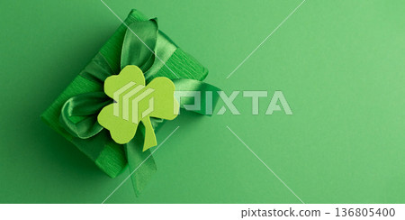 Green Gift Box with Shamrock on Green Background. Saint Patricks Day Celebration 136805400